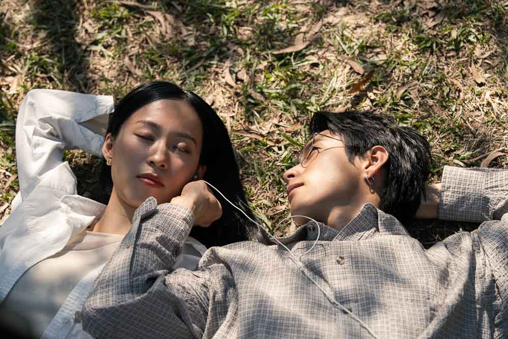 A couple lying together in a quiet outdoor moment