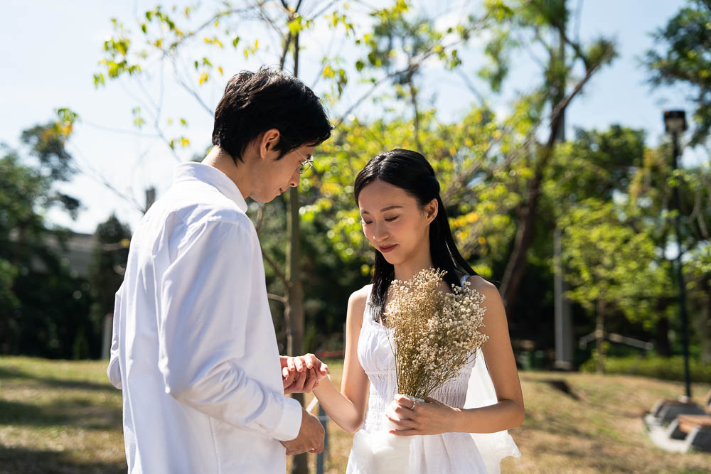 A ring being placed on a partner's finger