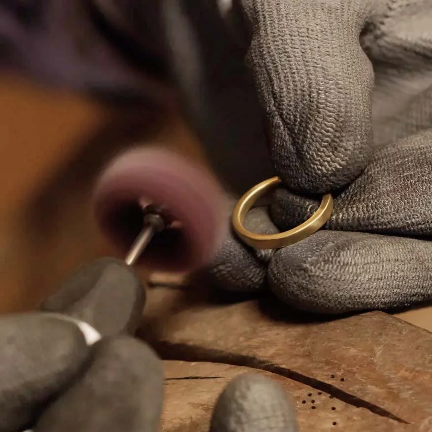 Studio hands working on jewellery with gloves and tools