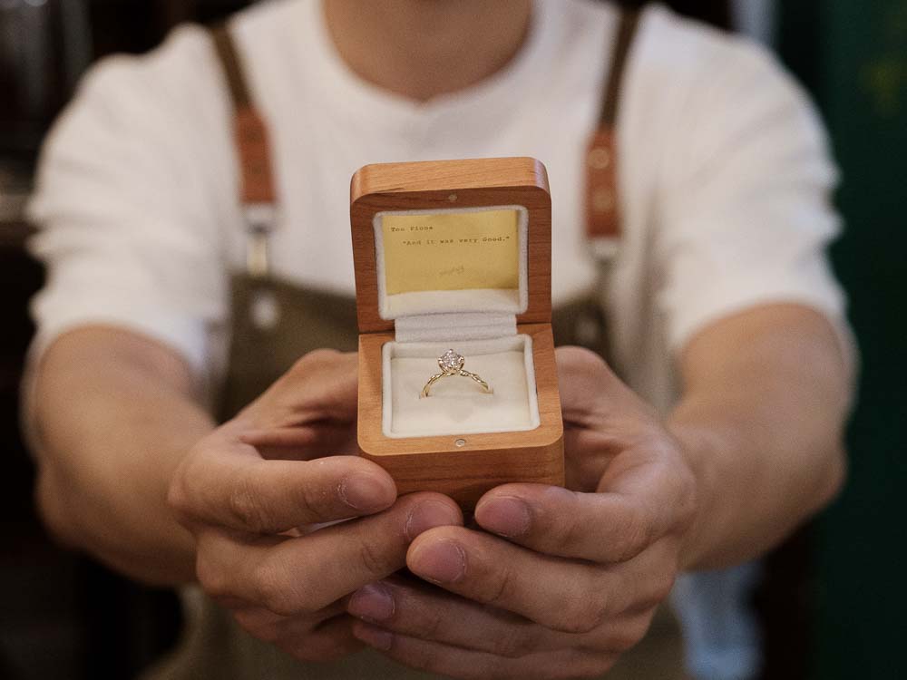 Finished engagement ring presented in a wooden ring box