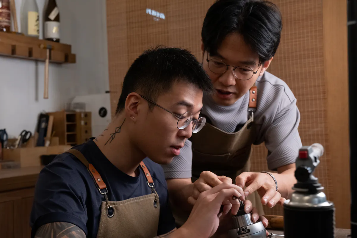 Jeweller guiding a participant during engagement-ring making