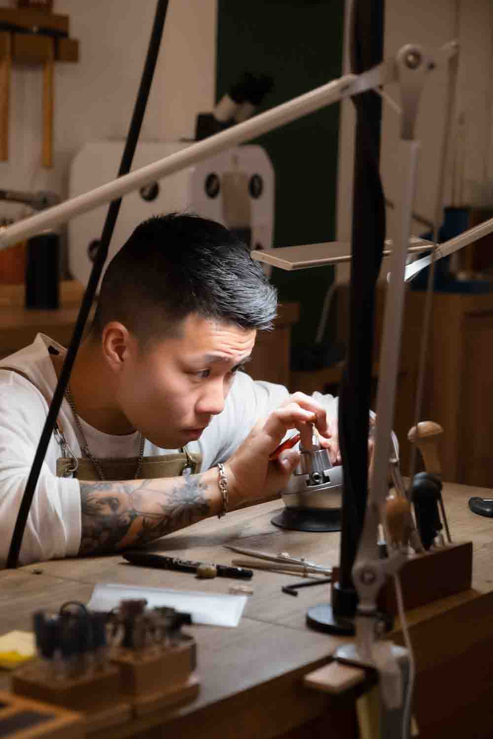 Focused workshop participant working at a jewellery bench