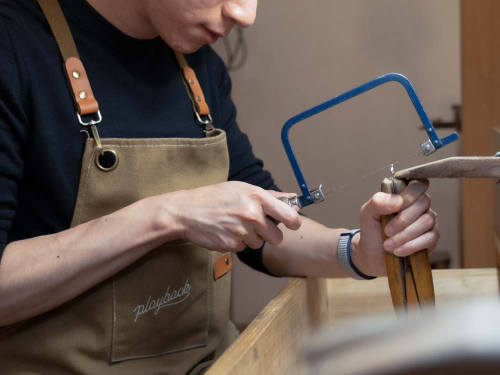 Jeweller working by hand at the workshop bench