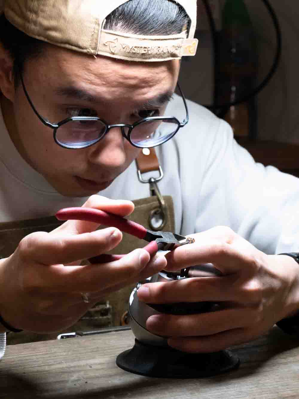 Jeweller concentrating on an engagement ring at the bench